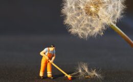 shallow focus photo of man holding floor brush ceramic figurine